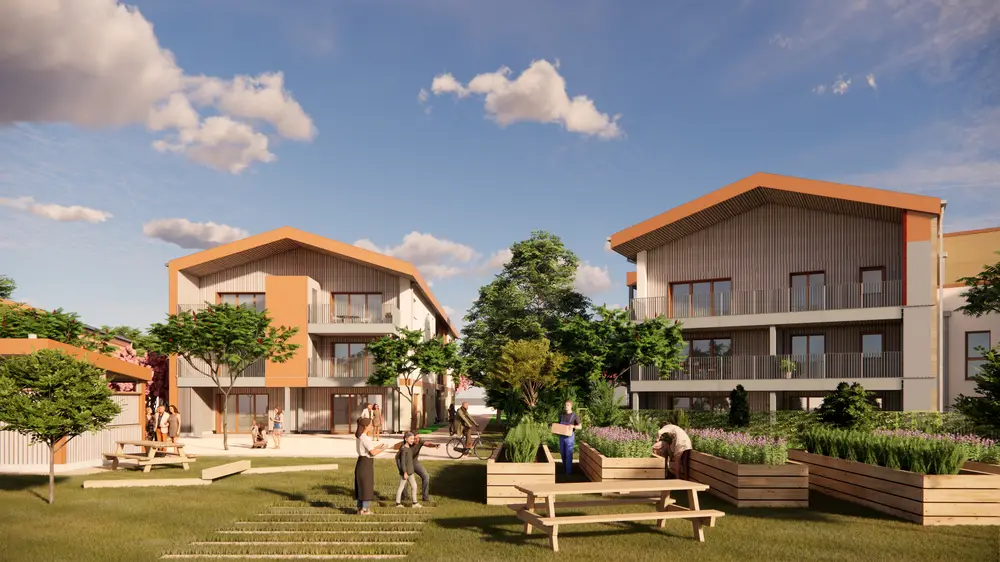Le potager collectif au pied des bâtiments, bacs en bois et pelouse.